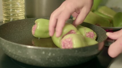 Savor these deliciously filled green peppers, stuffed to the brim with wellseasoned minced meat, all while being surrounded by the lively, bustling atmosphere of a busy kitchen