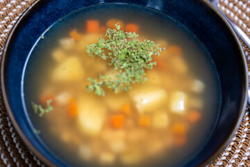 Homemade soup in a blue bowl – flavorful, healthy, and delicious, perfect for lunch or dinner in a cozy kitchen setting.
