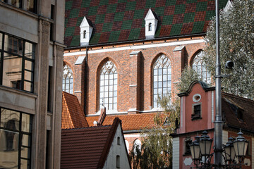 Majestic Gothic Revival church with ornate brick facade and arched windows in historic European city.