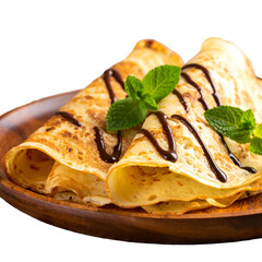 Golden crepes drizzled with chocolate, garnished with mint, on a wooden plate