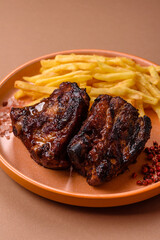 Grilled or barbecued pork ribs with sauce. Grilled ribs