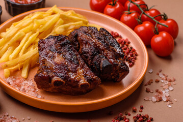 Grilled or barbecued pork ribs with sauce. Grilled ribs