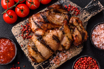 Chicken breast cooked on a grill or barbecue with sauce. Grilled chicken