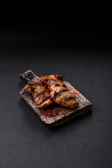 Chicken breast cooked on a grill or barbecue with sauce. Grilled chicken