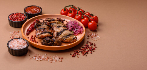 Chicken breast cooked on a grill or barbecue with sauce. Grilled chicken