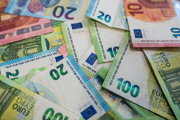 Scattered Euro banknotes in various denominations symbolizing wealth, cash flow and investment