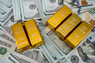 Financial concept with gold bars and US dollars, symbol of success, capital wealth and money growth