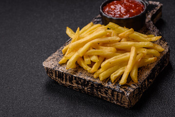 French fries cooked in oil, crispy golden chips, unhealthy food. French fries as a background