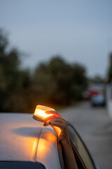 v16 Woman placing emergency beacon light on broken down car