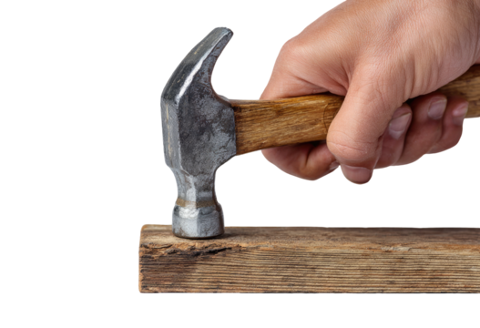 A hand wielding a hammer, driving a nail into a weathered wooden plank