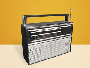 old retro blue radio receiver on yellow background,