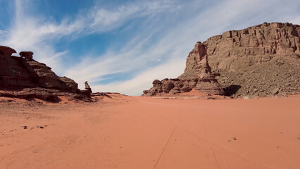 A trip to Sahara desert in Algeria. Beautiful 
african travel photo. Sandy landscapes, mountains, rocks,
dunes, and nature. Summer vacation in arab country.