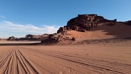 A trip to Sahara desert in Algeria. Beautiful 
african travel photo. Sandy landscapes, mountains, rocks,
dunes, and nature. Summer vacation in arab country.