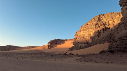 A trip to Sahara desert in Algeria. Beautiful 
african travel photo. Sandy landscapes, mountains, rocks,
dunes, and nature. Summer vacation in arab country.