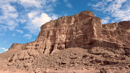 Fototapeta premium A trip to Sahara desert in Algeria. Beautiful african travel photo. Sandy landscapes, mountains, rocks, dunes, and nature. Summer vacation in arab country.