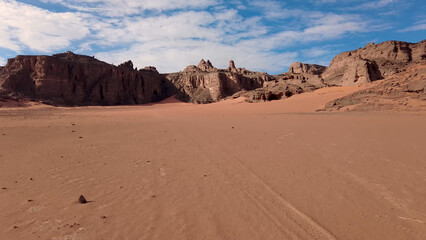 A trip to Sahara desert in Algeria. Beautiful 
african travel photo. Sandy landscapes, mountains, rocks,
dunes, and nature. Summer vacation in arab country.