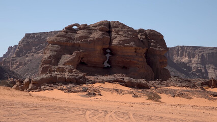 A trip to Sahara desert in Algeria. Beautiful 
african travel photo. Sandy landscapes, mountains, rocks,
dunes, and nature. Summer vacation in arab country.