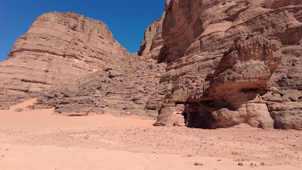 Fototapeta premium A trip to Sahara desert in Algeria. Beautiful african travel photo. Sandy landscapes, mountains, rocks, dunes, and nature. Summer vacation in arab country.
