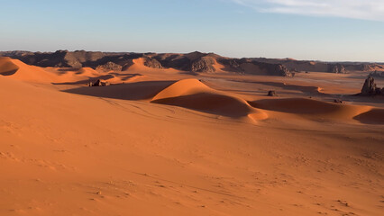 A trip to Sahara desert in Algeria. Beautiful 
african travel photo. Sandy landscapes, mountains, rocks,
dunes, and nature. Summer vacation in arab country.