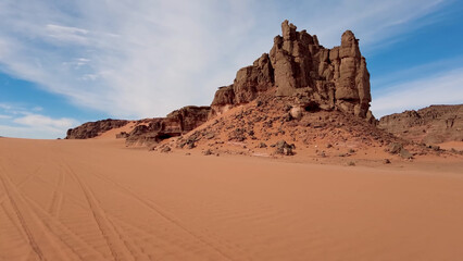A trip to Sahara desert in Algeria. Beautiful 
african travel photo. Sandy landscapes, mountains, rocks,
dunes, and nature. Summer vacation in arab country.