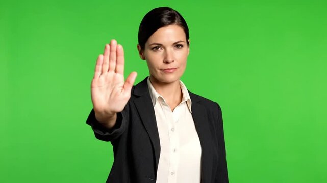 Assertive Businesswoman Making a Stop Gesture on Green Screen.