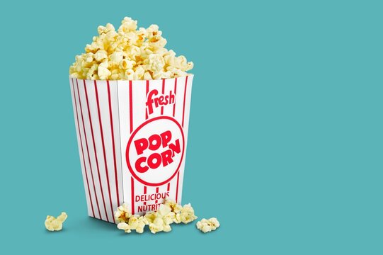 A classic striped popcorn box with delicious popped popcorn - Powered by Adobe