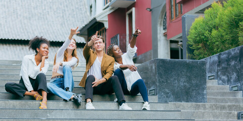 Fototapeta premium Portrait of creative marketing team of young diverse professionals standing together outdoors, showing confidence, teamwork, leadership, and collaboration in modern business environment