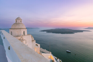 Church dome and Aegean Sea caldera at sunset in Fira on the island of Santorini, Greece
