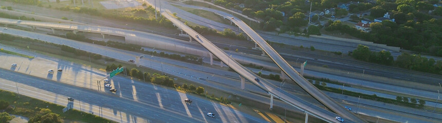 Panorama aerial Fort Worth stacked interchange at sunrise, layered ramps of I-35W and I-30 with...