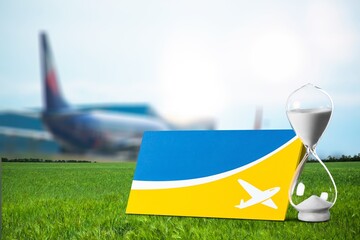 Old glass sand clock and plane ticket