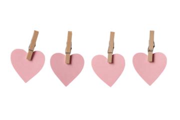 Four pink hearts, each attached to a clothespin, arranged horizontally on a plain background