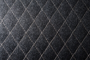 Naklejka premium Close-Up of Quilted Dark Fabric with Diamond Stitch Pattern
