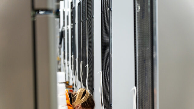 A woman is at work in a data center
