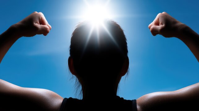 Silhouette of strong female with sunburst against clear blue sky - Powered by Adobe