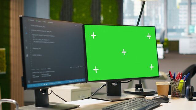 Green screen computer display in modern startup office displaying code snippets in various programming languages used for software development. Chroma key PC in empty software agency workplace