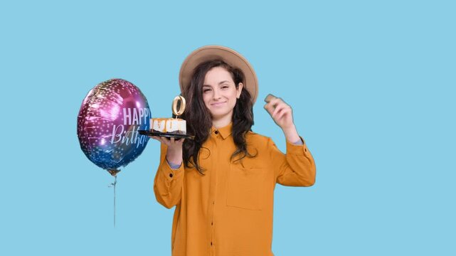 Stylish woman celebrating with birthday cake with number 30 on the blue chroma key