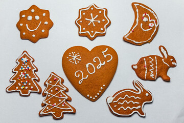 Homemade Christmas gingerbread cookies decorated and covered with white icing for the New Year's holiday. Ready-to-eat gingerbread cookies - fun patterns and shapes, a sweet holiday treat