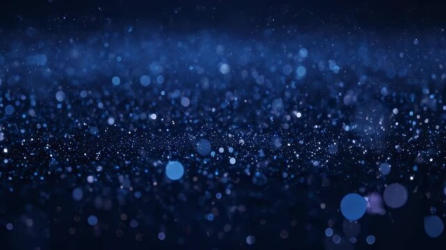 A dark blue, bokeh-filled image with floating particles, reminiscent of stardust