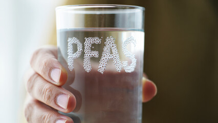 PFAS in drinking water, toxic contamination risk, hand holding glass, invisible chemical danger, health hazard alert, polluted tap water, forever chemicals, unsafe consumption © olgakris