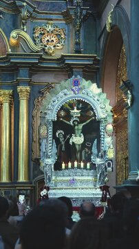 LIMA, Peru. 06 october 2025: Faithful believers gathering around an elaborate silver processional float before a religious parade