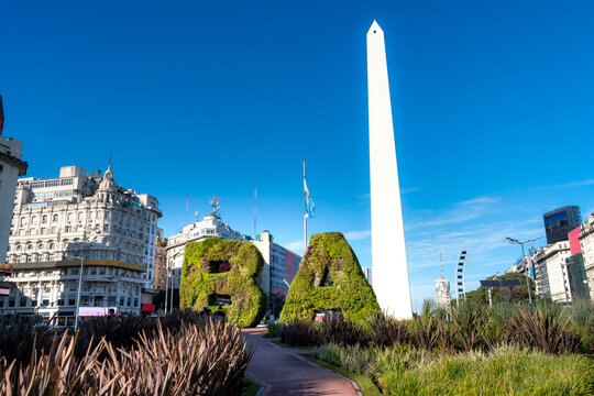 The iconic BA letters covered in plants stand in front of the towering Obelisco in Buenos Aires. Captured on a bright day, this landmark reflects the capital&rsquo;s beauty, nature and architectural charm.
