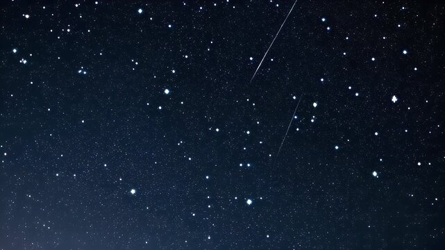 A dark blue night sky studded with numerous bright stars, with a shooting star or meteor