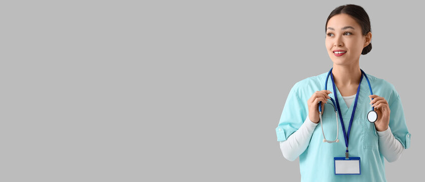 Female Asian doctor with stethoscope on light background. International Nurses Day