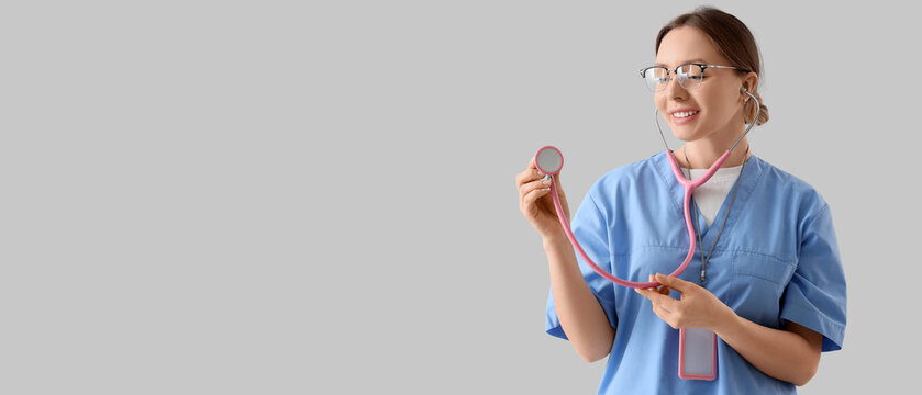 Female doctor with stethoscope on light background. International Nurses Day