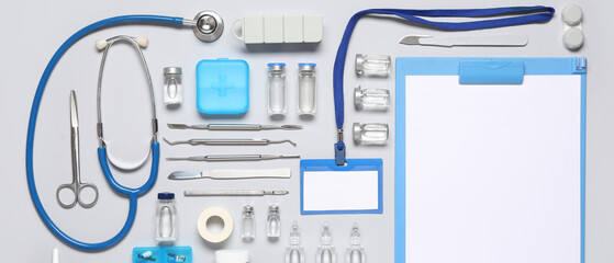 Clipboard and medical supplies with scalpel, surgical plaster and injections on grey background....