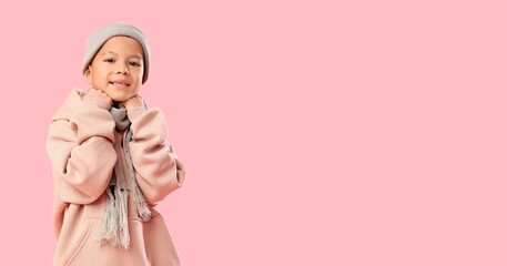 Little Asian boy in warm clothes on pink background with space for text