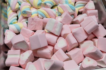 Snack bar cart with colorful and flavored candies and sweets, marshmallows, and fruit jellies for parties and events to serve in small cups.

