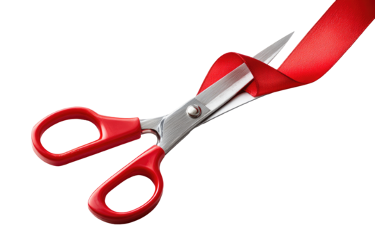 Red ribbon-cutting scissors.  Sharp scissors with red handles are cutting a red ribbon against a black background.  Close-up view