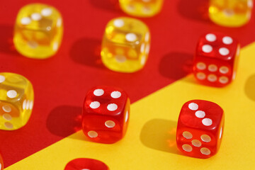 Yellow and red dices on color background