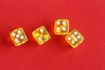 Yellow game dices on red background